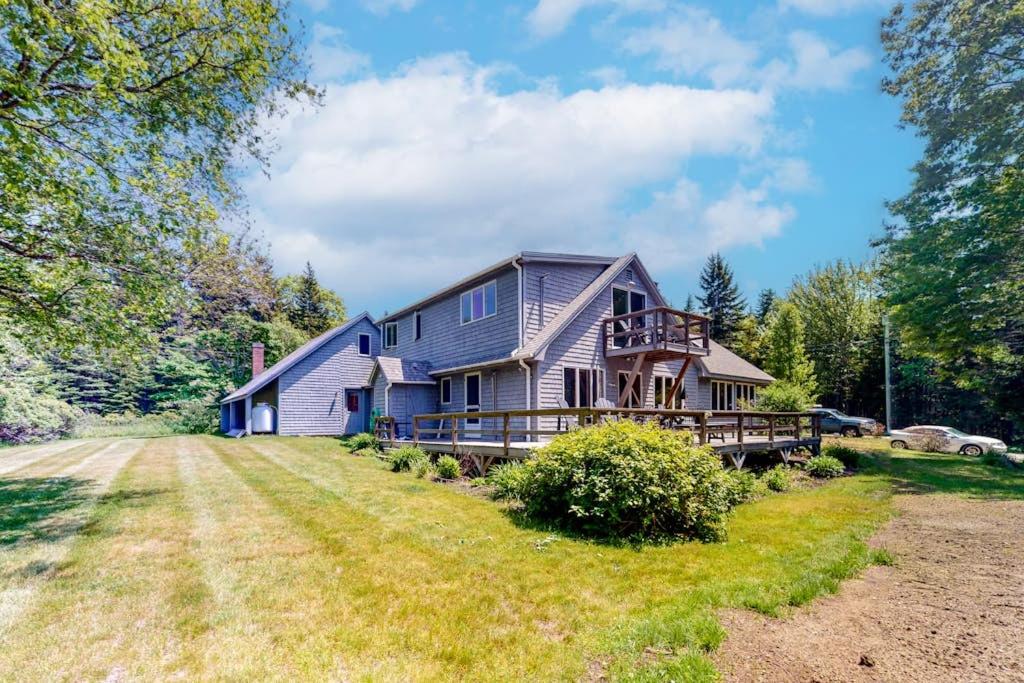 a large house with a porch on a lawn at Dog-friendly beach house with WiFi, private washer/dryer, deck, beautiful views in Bristol