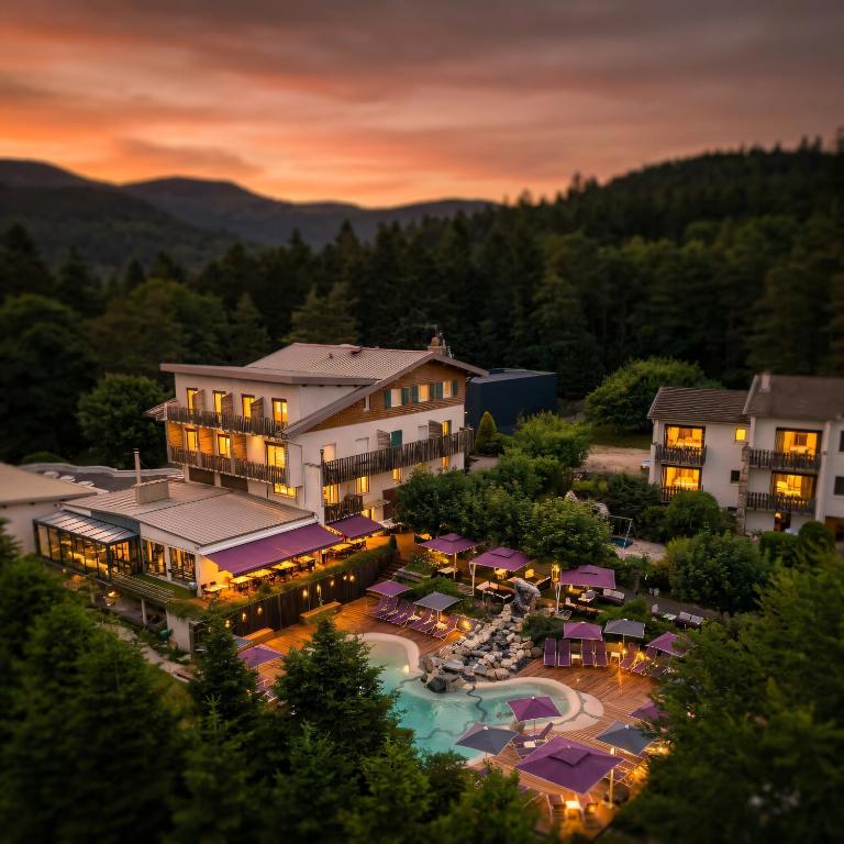 an aerial view of a resort with a swimming pool at Logis Clair Matin Resort & Spa in Le Chambon-sur-Lignon