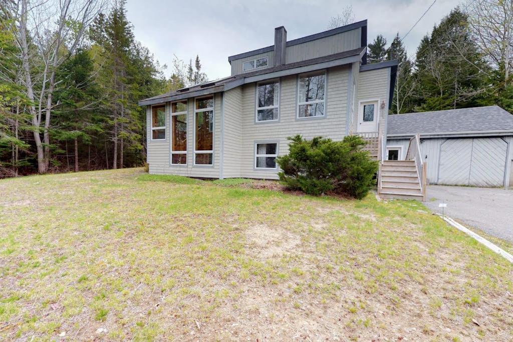 a house with a large yard in front of it at Home with deck, great location in the heart of Acadia National Park in Otter Creek