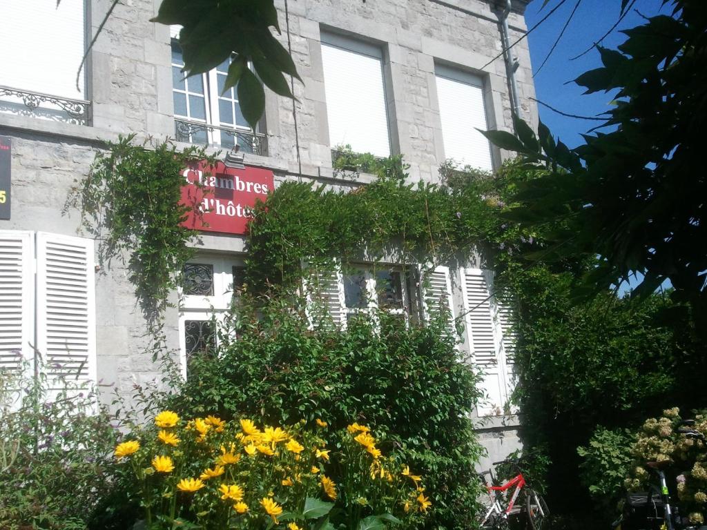 a building with a sign on the side of it at Le Point du Jour in Revin