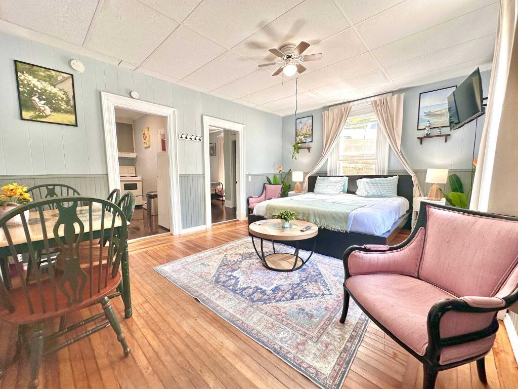 a living room with a bed and a table and chairs at King Bed 2BR near the LaHave River and Trails in Bridgewater