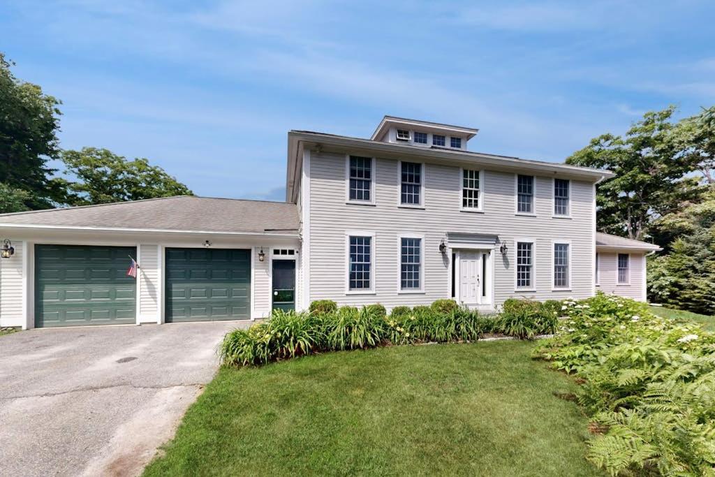 a large white house with a driveway at Expansive Modern Home w/ Ocean View, Gorgeous Garden & Dog-friendly in East Boothbay