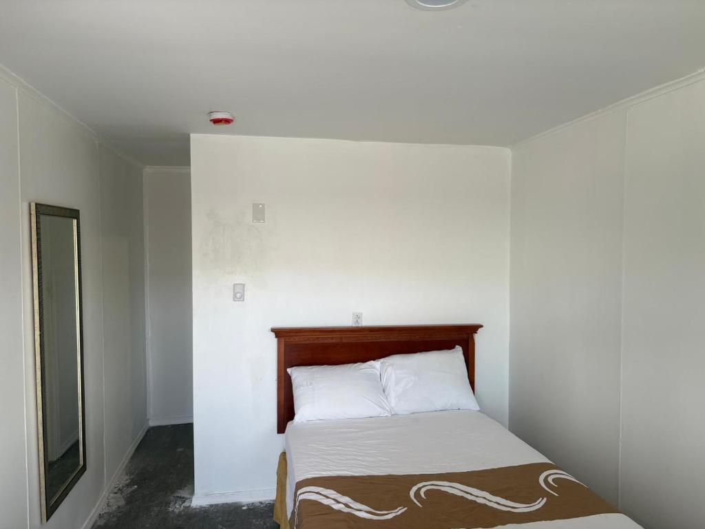 a small bedroom with a bed and a tv at Royal Motel in Allentown