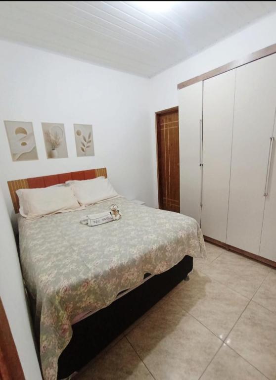 a bedroom with a bed and white cabinets at Aluguel de quarto com suite in Aracaju