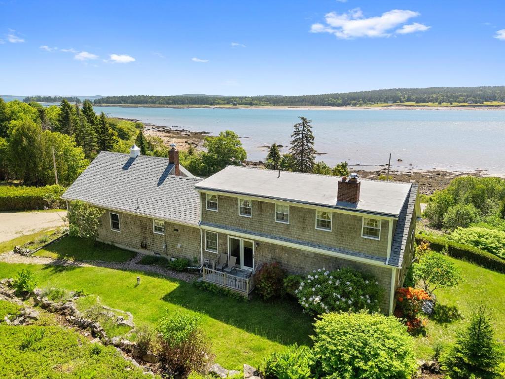 an aerial view of a house on the water at Dog-friendly oceanfront home with private shorefront, two fireplaces, & firepit in Steuben