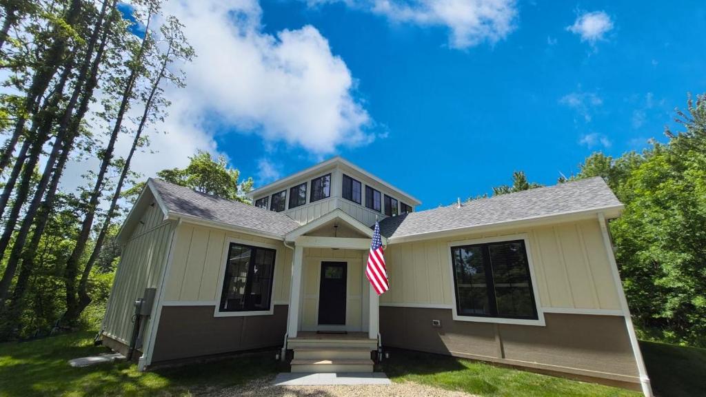 a house with an american flag in front of it at Prairie View in Sawyer
