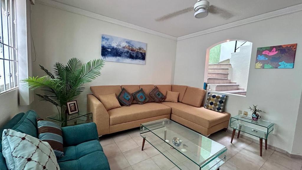 a living room with a couch and a glass table at Casa Corazón de Boca, steps from the beach and restaurants in Boca del Río