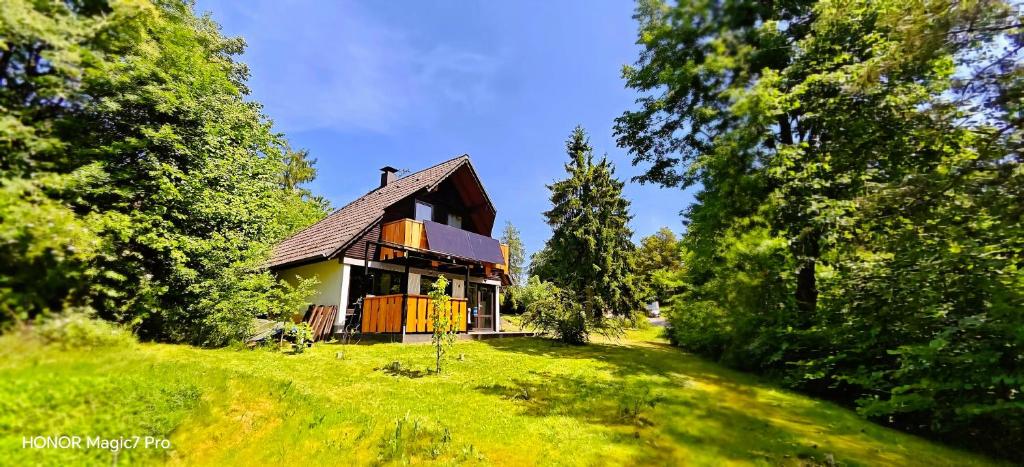 a small house on a hill in a field at Ferienhaus Laange in Frankenau