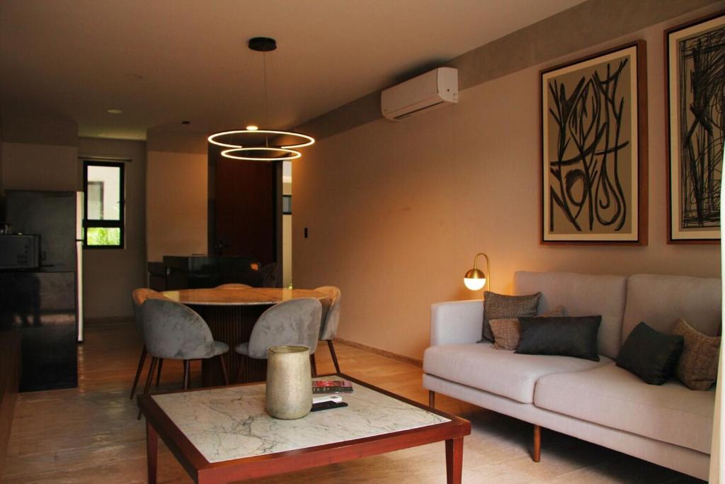 a living room with a couch and a table at Exclusive Boutique Apartment in Mérida Norte in Mérida