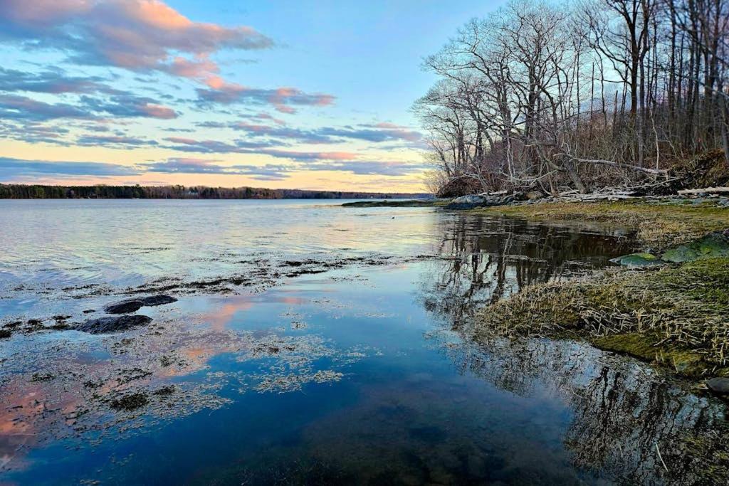 a view of a body of water with trees and clouds at Spacious House with Modern Comforts and Nature in Cushing