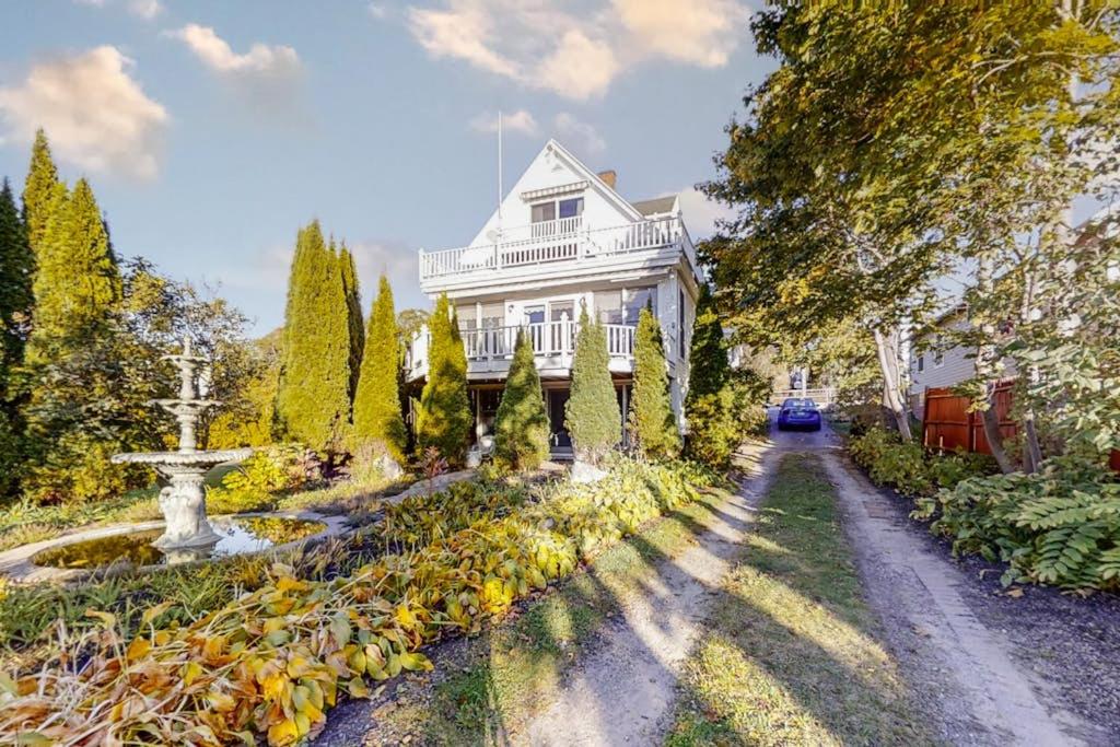 a white house with a garden and a street at Oceanfront house with dock, kayaks, deck, and gas grill in Boothbay Harbor