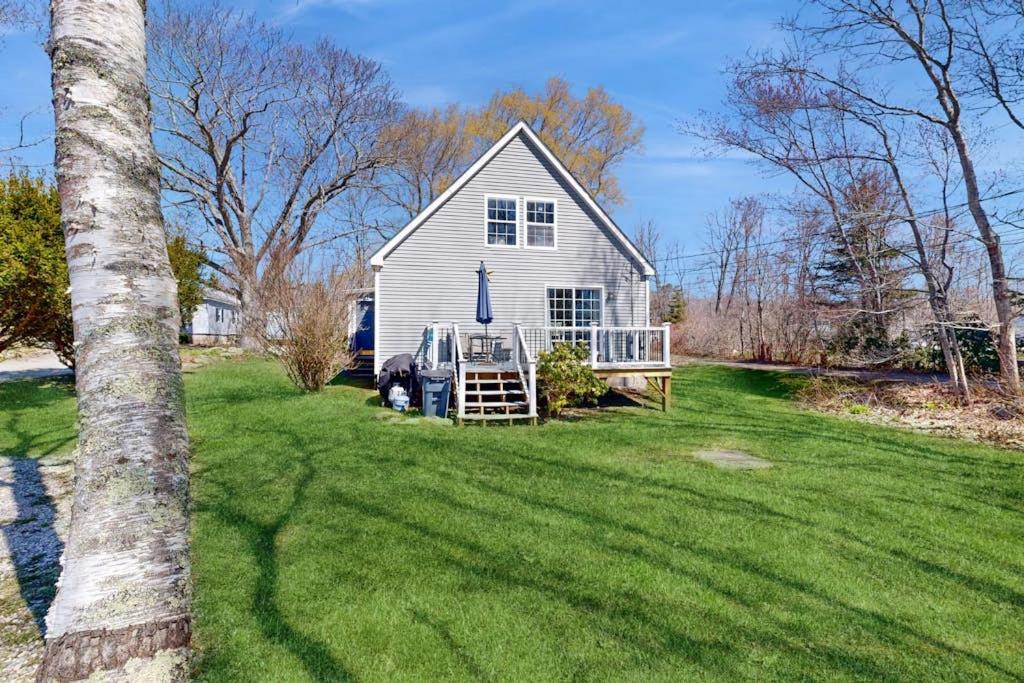 a white house with a truck parked in a yard at Dog-friendly home with deck, pool table, & firepit - walk to downtown Boothbay in Boothbay Harbor