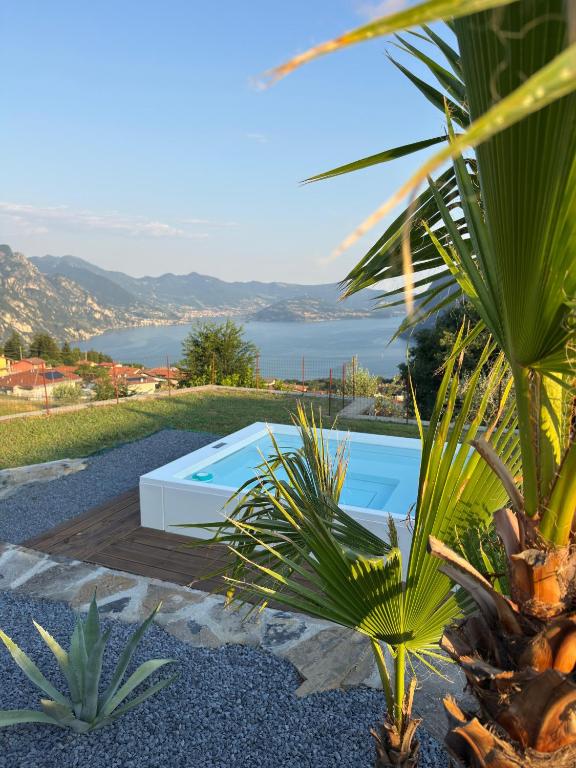 a swimming pool with a view of the water at Corte Furmignano in Solto Collina