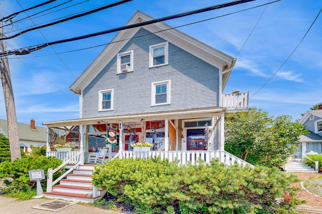 a gray house with a white porch at Nautical vacation rental in in walkable downtown with harbor view, grill & deck in Boothbay Harbor