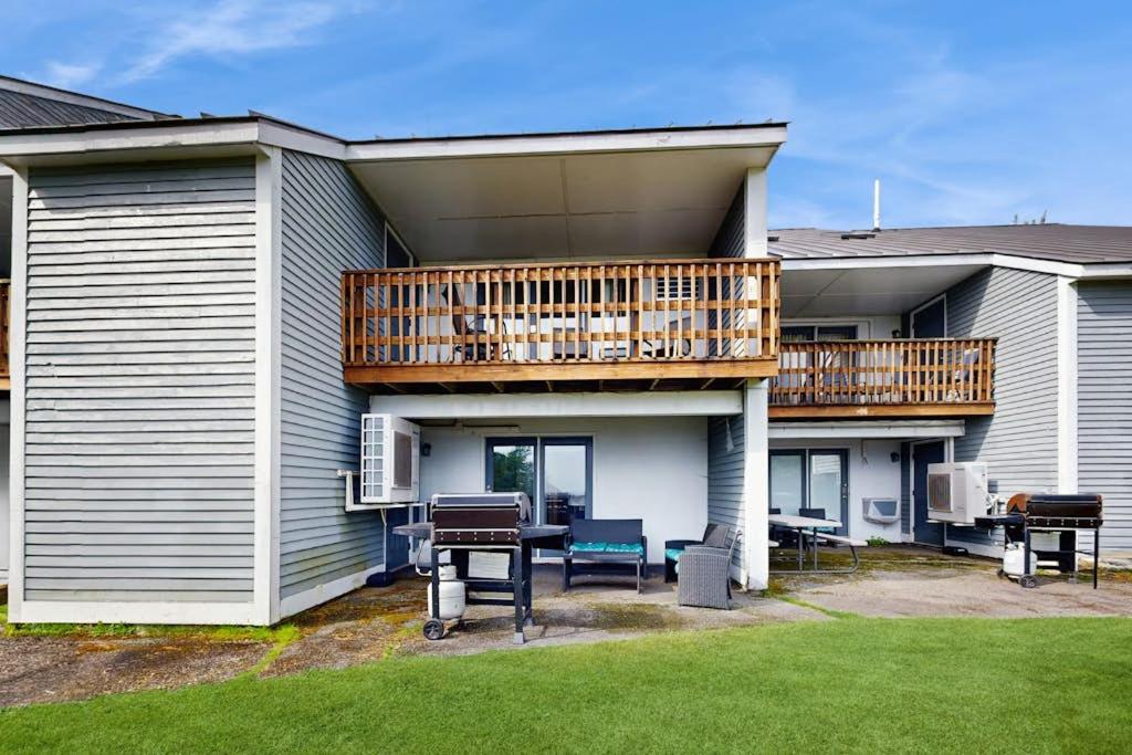 a house with a balcony with a table and a deck at Dog-Friendly Townhouse w/Bay Views, Fast WiFi, and Partial A/C in Bar Harbor