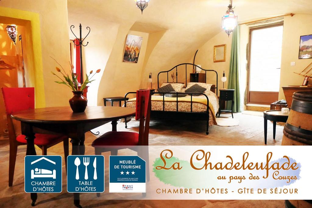 a room with a table and a bed in a room at Chambre d'Hôtes La Chadeleufade in Chadeleuf