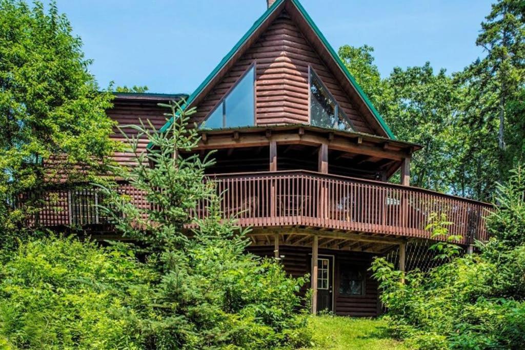 a large log cabin with a wrap around deck at Stunning & Spacious Log Cabin in the Woods in Boothbay Harbor