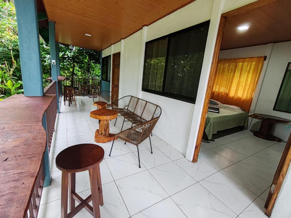 a balcony with tables and chairs on a house at Cabinas Toucan in Chachagua