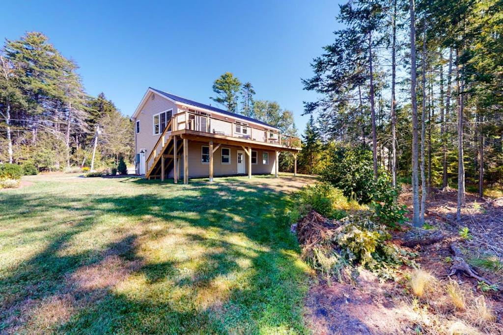 a large house in the middle of a yard at Newly-built waterfront home with fast WiFi, furnished deck, & washer/dryer in Waldoboro