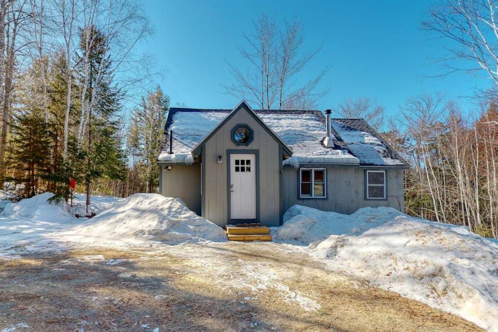 a small house with snow in front of it at Cozy woodsy Cabin w/ a Deck, Firepit, Gas Grill, Free WiFi, & Full Kitchen in Greenville