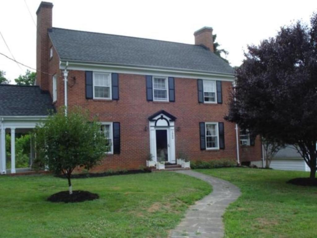 a red brick house with a tree in the yard at Welcome to your private cozy room #2 near LU, Stadium & general hospital in Lynchburg