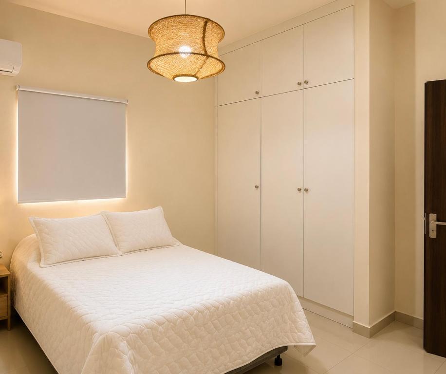 a bedroom with a bed and a white cabinet at Eco Avalon Paradise Villa in Punta Cana