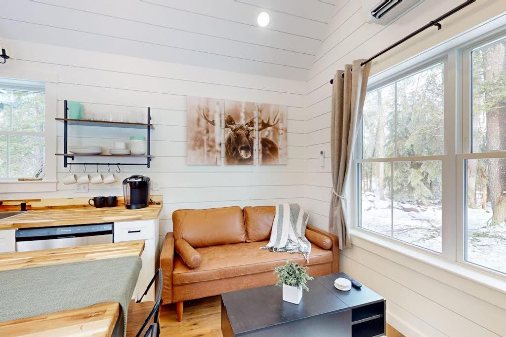 a living room with a couch and a table at Brand-new dog-friendly home near Hancock Pond with firepit, grill, streaming, AC in Bucksport
