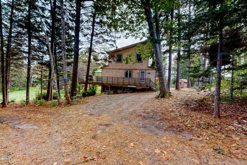 a house in the middle of a forest at Dog-friendly 3-story home with wood stove, deck, grill, ocean views, W/D, AC in Southwest Harbor