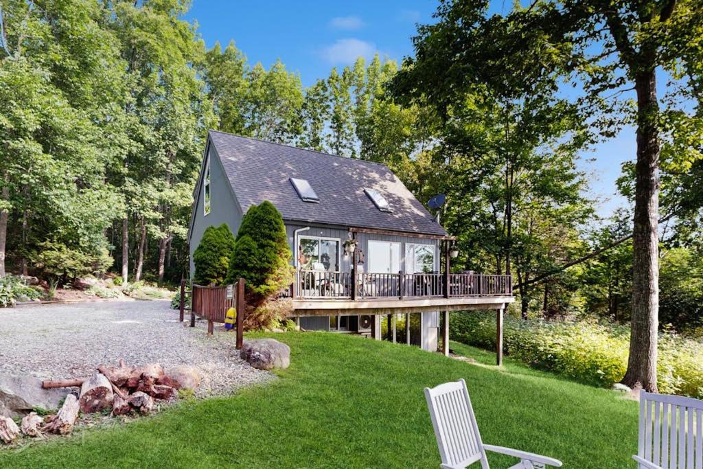 a house with a deck and a porch at Oceanfront snowbird-friendly home on the beach with washer/dryer & fireplace in Lincolnville
