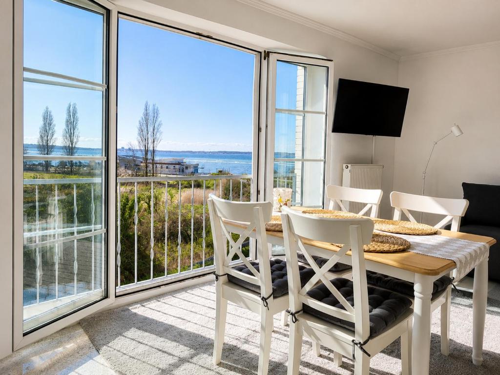 a dining room with a table and views of the ocean at Kiek ut in Stein