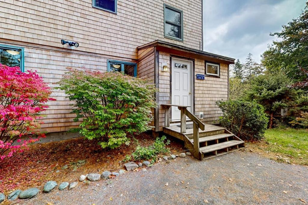 a house with a staircase leading to a door at Dog-friendly ocean-view home with grill, wood stove, deck, washer/dryer, & AC in Southwest Harbor