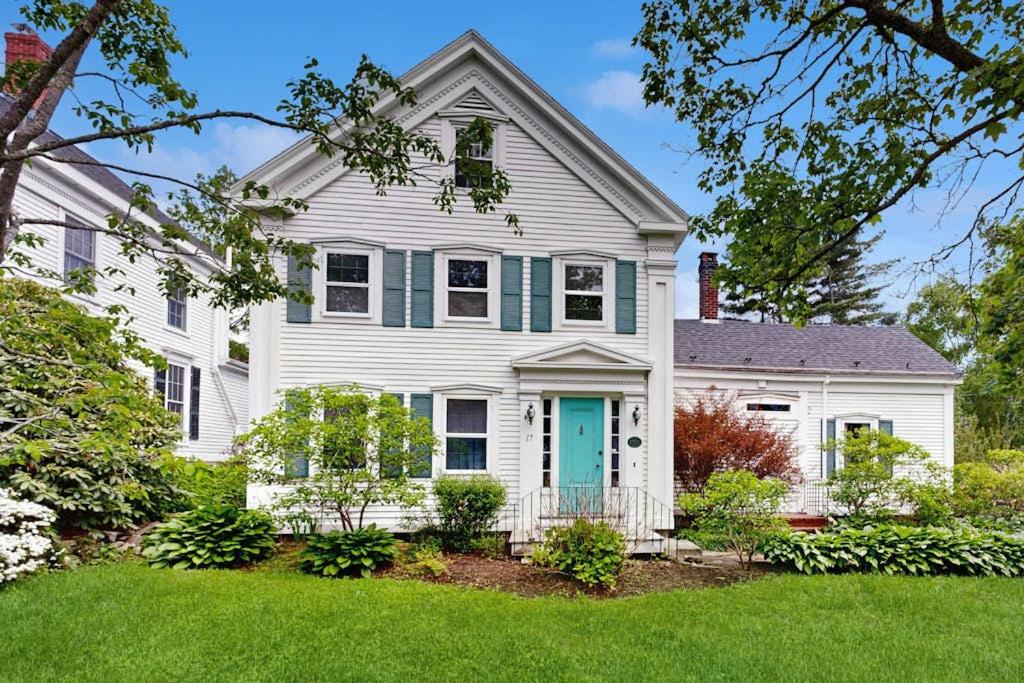a white house with a blue door at Elegant Historic Home with Refined Interiors and Private Outdoor Spaces in Camden