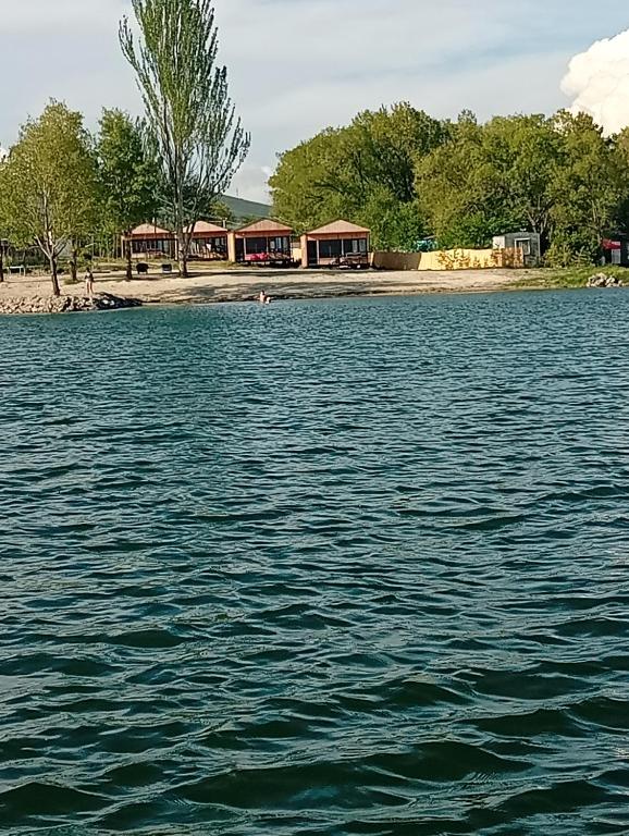 a large body of water with houses in the background at Sevanta Lake Cottages in Sevan