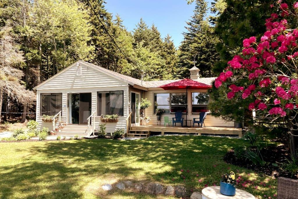 a small house with a porch and a yard at Ocean-view cottage near beach with deck, grill, & full kitchen in Bristol