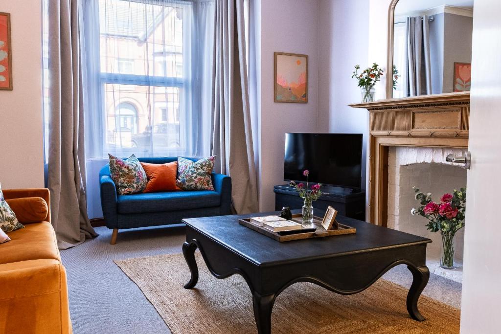 a living room with a couch and a coffee table at Spacious One-Bed Apartment in Chester in Chester