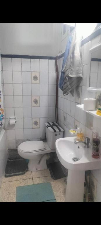 a small bathroom with a toilet and a sink at Maison Bab boujloud in Fez