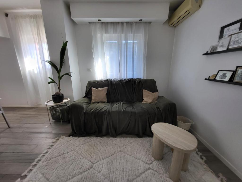 a living room with a couch and a table at Garden in Šibenik