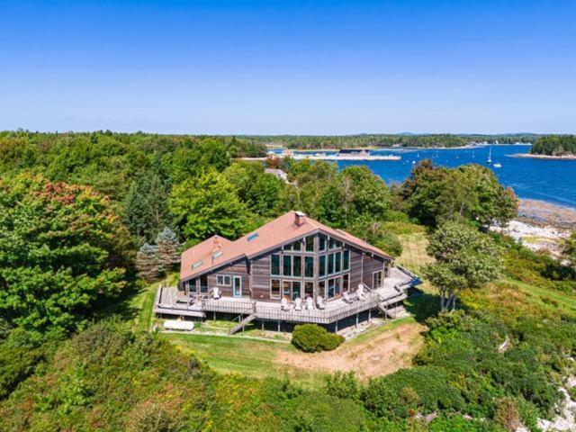 an aerial view of a large house on a hill at Clark Point Cottage, ocean access, panoramic views in Clark Island