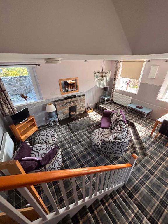 a living room with a couch and a fireplace at Apartment Sleeps 2 with WiFi in Wick