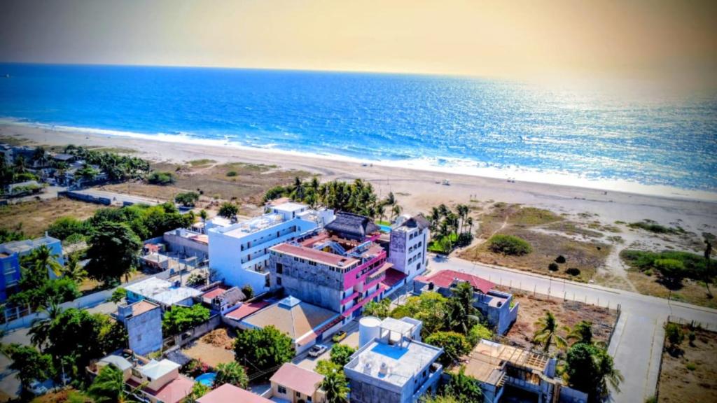 an aerial view of a beach with buildings and the ocean at Aruma Stays in Brisas de Zicatela