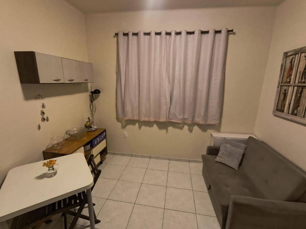 a living room with a couch and a table at Apartamento Mobiliado - Botafogo in Rio de Janeiro