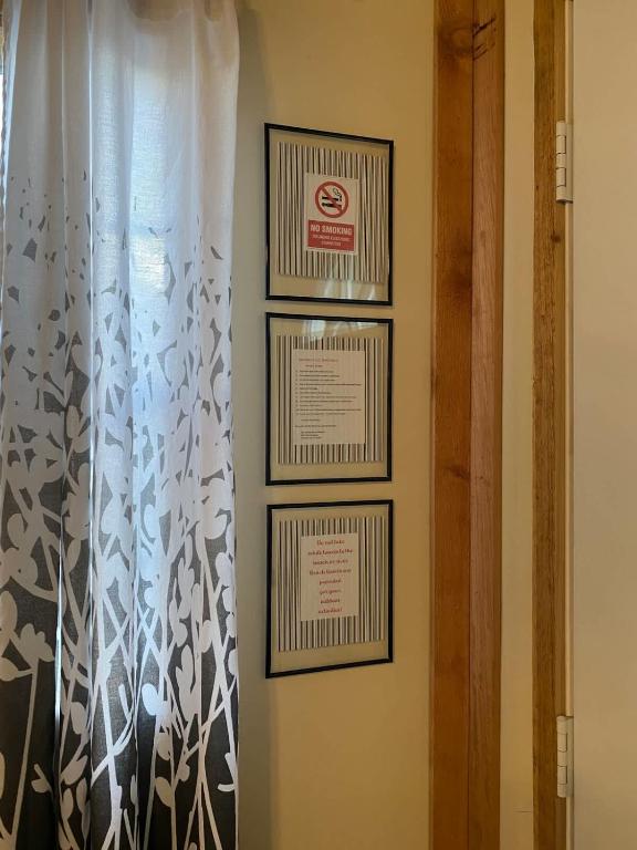a room with two framed pictures and a curtain at Hill Country Cabin 2 in Canyon Lake