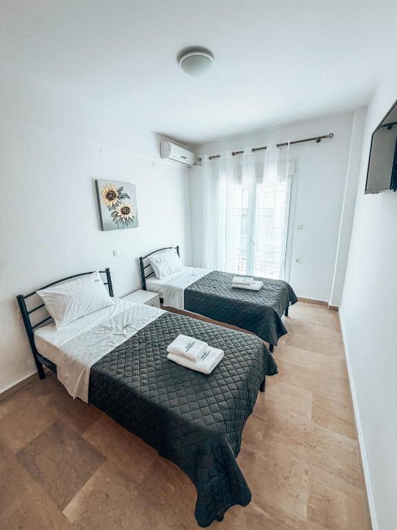 a room with two beds in a room at Hotel Galini Polychrono in Polychrono