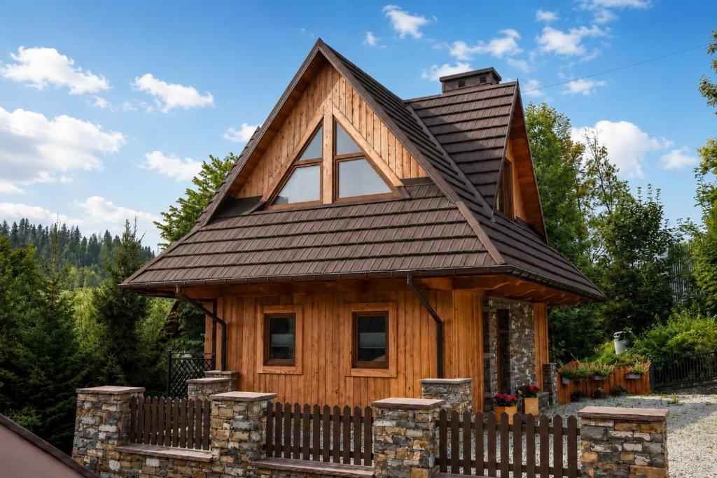 a tiny house with a gambrel roof at Domek Jatka No 1 in Zakopane
