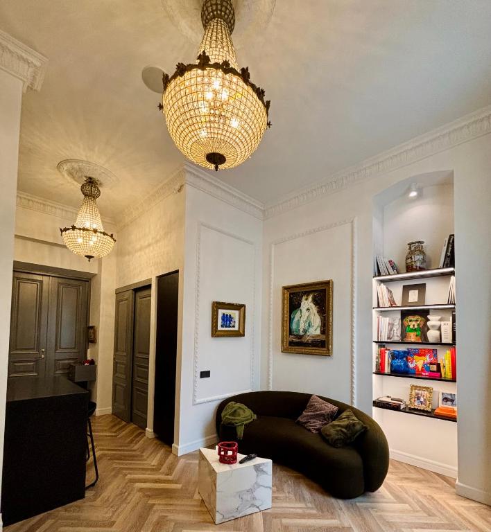 a living room with a couch and a chandelier at The Gediminas Residence in Vilnius