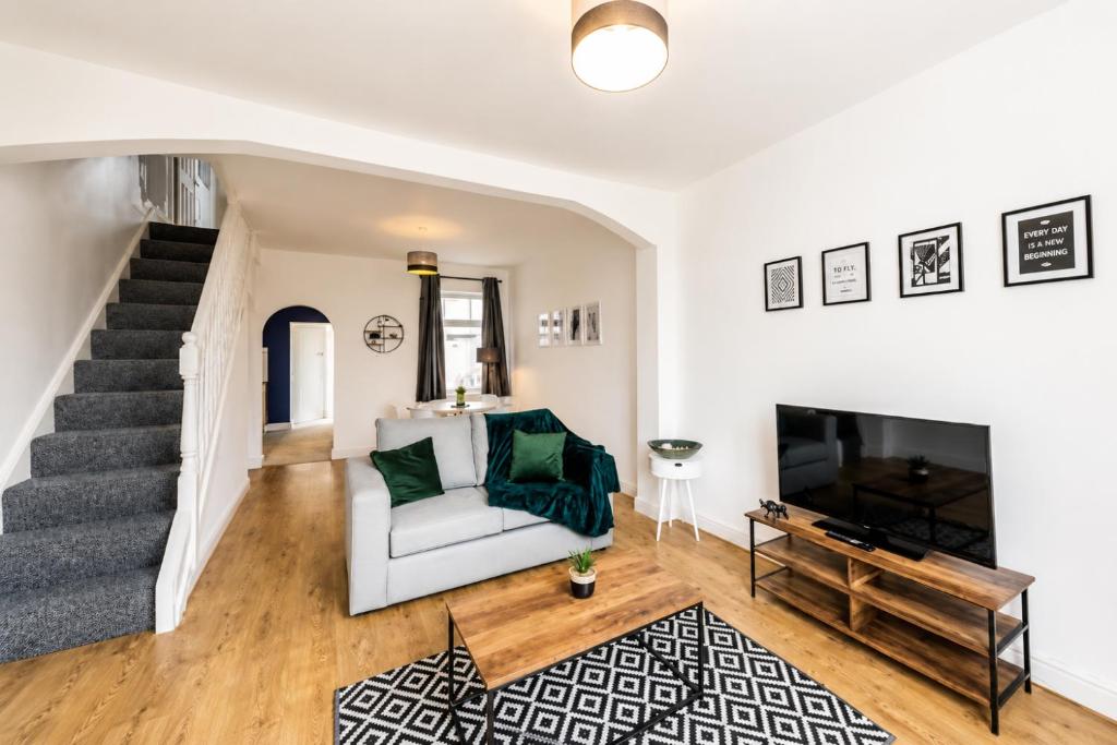 a living room with a couch and a television at York House - Garston - 3 bedroom - Sleeps 6 in Liverpool