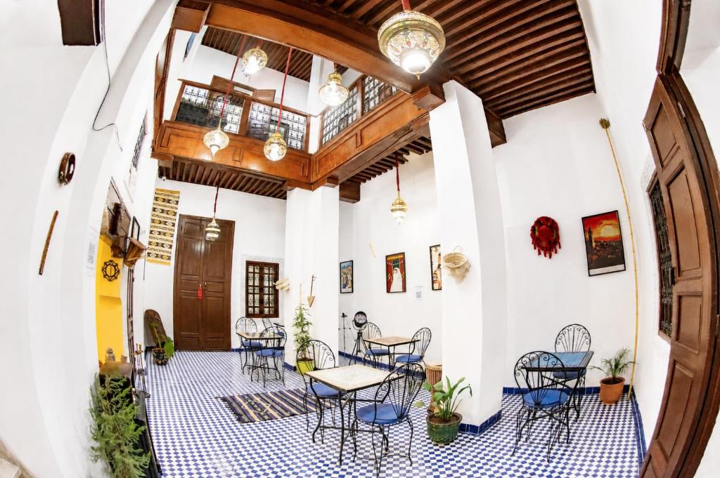 a patio with chairs and tables in a building at Dar Mayssa Fez in Fez
