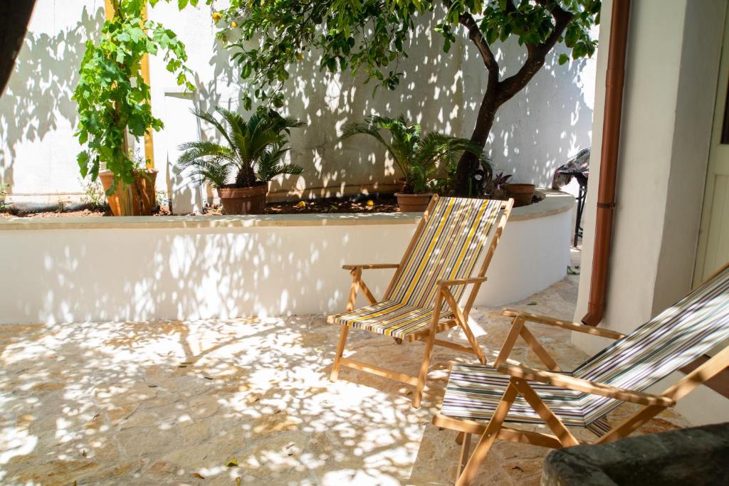 two rocking chairs sitting on a porch with plants at da Mescia Maria in Morciano di Leuca