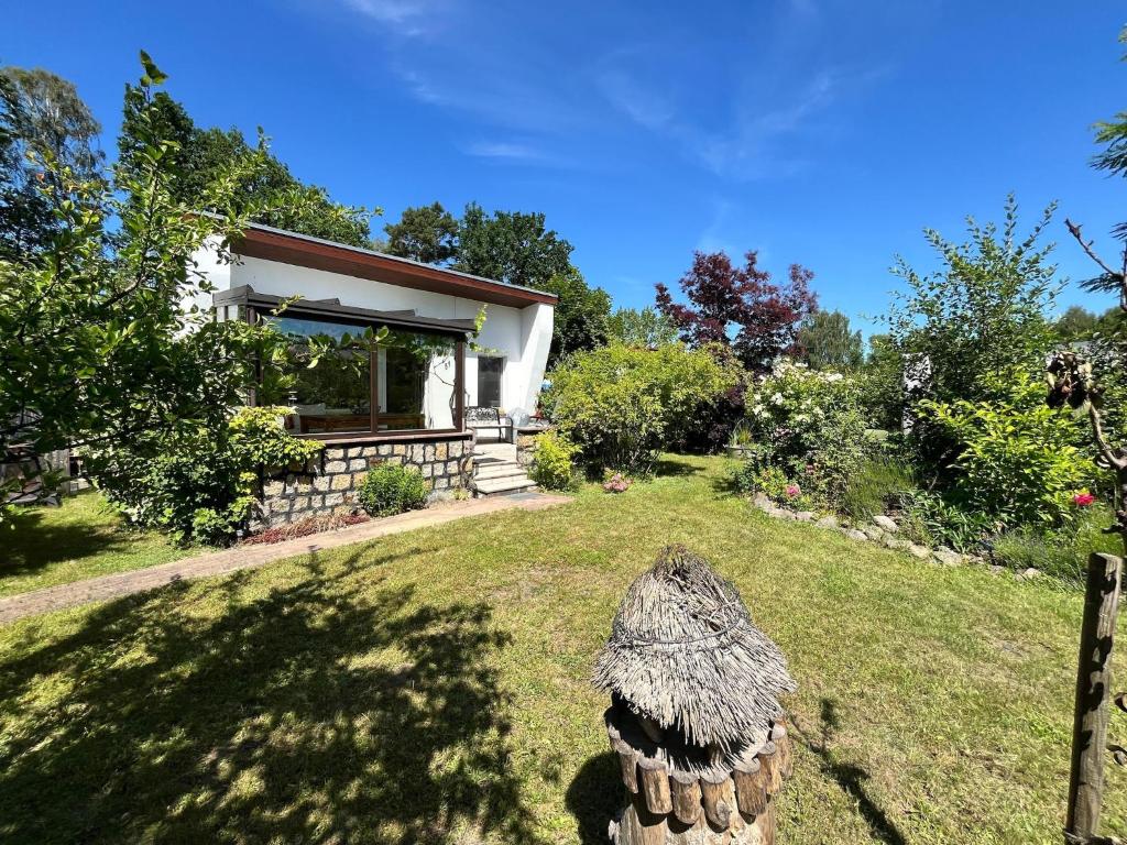 a house with a grassy yard in front of it at Bungalow Louise in Dobbertin in Dobbertin