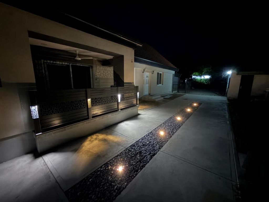 an empty patio at night with lights on it at Apartmani L&V in Kula